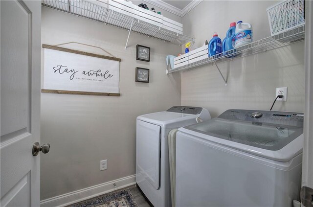 laundry room with ornamental molding and washing machine and clothes dryer