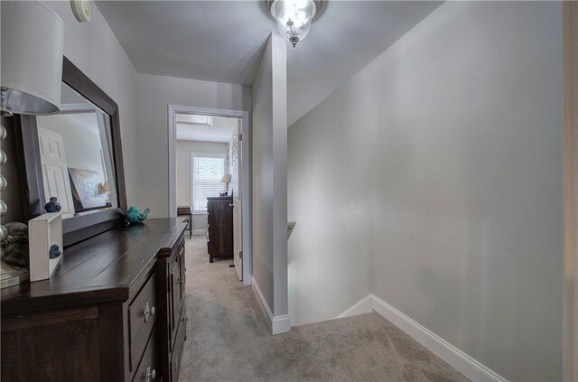 hallway featuring light carpet