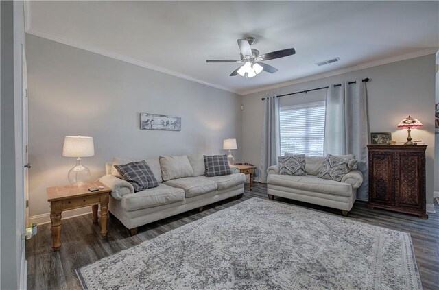 living room with crown molding, dark wood-type flooring, and ceiling fan