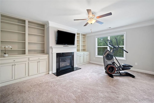 2385 Saddle Brook Trce, Cumming, GA 30040 - exercise area featuring a glass covered fireplace, carpet floors, ornamental molding, baseboards, and ceiling fan