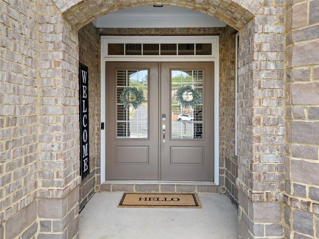 2385 Saddle Brook Trce, Cumming, GA 30040 - view of exterior entry featuring french doors and brick siding