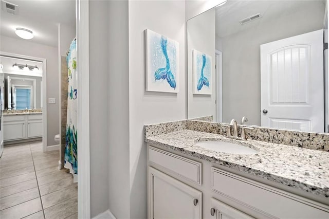 2385 Saddle Brook Trce, Cumming, GA 30040 - full bath featuring tile patterned flooring, vanity, baseboards, toilet, and curtained shower