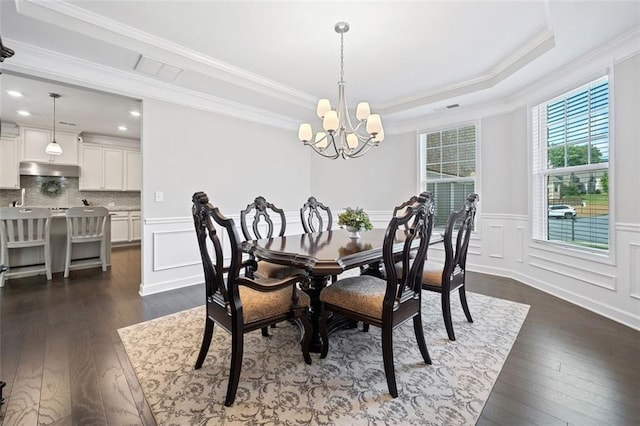 2385 Saddle Brook Trce, Cumming, GA 30040 - dining space with dark wood-style flooring, a chandelier, crown molding, a decorative wall, and a wainscoted wall