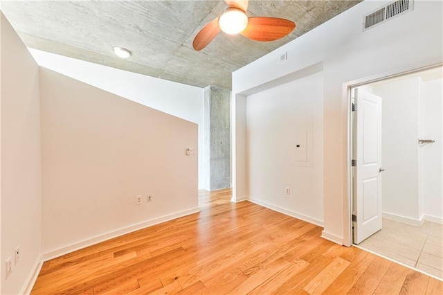 empty room featuring ceiling fan and light wood-type flooring