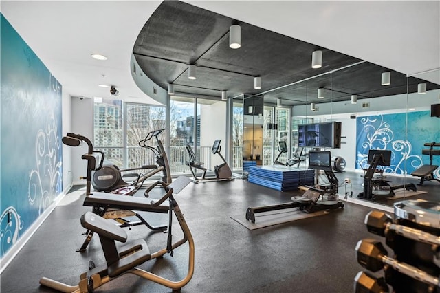 gym with a wall of windows