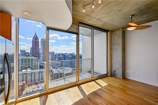 unfurnished sunroom with ceiling fan