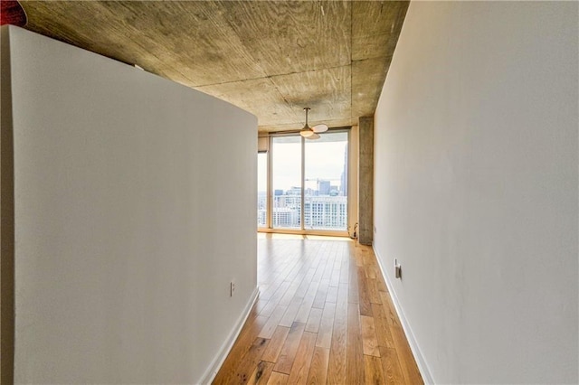 corridor featuring hardwood / wood-style flooring and floor to ceiling windows