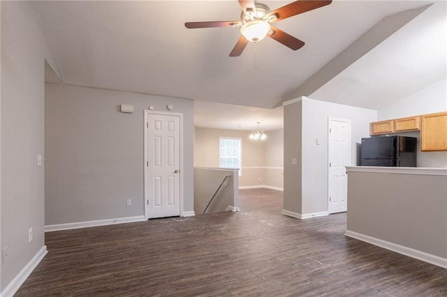 5069 Jonesboro Rd, Union City, GA 30291 - unfurnished living room with vaulted ceiling, a chandelier, dark wood-style floors, and a ceiling fan