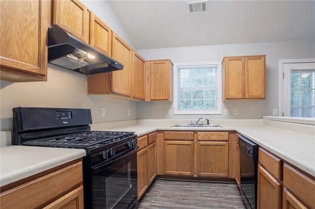 5069 Jonesboro Rd, Union City, GA 30291 - kitchen with black appliances, under cabinet range hood, wood finished floors, light countertops, and vaulted ceiling