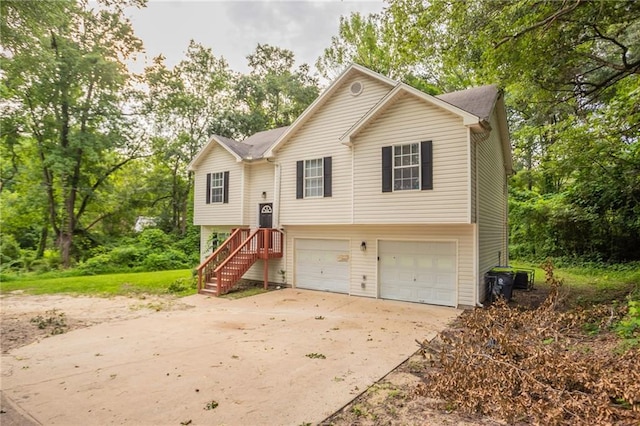 5069 Jonesboro Rd, Union City, GA 30291 - raised ranch featuring driveway, an attached garage, and view of scattered trees