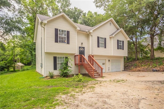 5069 Jonesboro Rd, Union City, GA 30291 - split foyer home with concrete driveway, an attached garage, and a front lawn