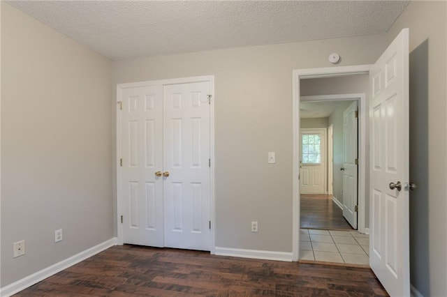 5069 Jonesboro Rd, Union City, GA 30291 - unfurnished bedroom featuring wood finished floors, a closet, and a textured ceiling