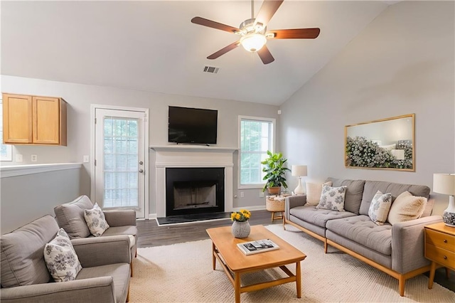 5069 Jonesboro Rd, Union City, GA 30291 - living area with ceiling fan, wood finished floors, a fireplace with raised hearth, and high vaulted ceiling