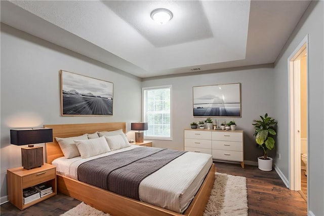 5069 Jonesboro Rd, Union City, GA 30291 - bedroom with a tray ceiling and dark wood-style floors