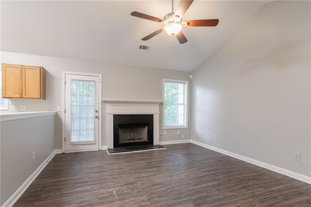 5069 Jonesboro Rd, Union City, GA 30291 - unfurnished living room featuring vaulted ceiling, dark wood-type flooring, ceiling fan, and a fireplace with raised hearth
