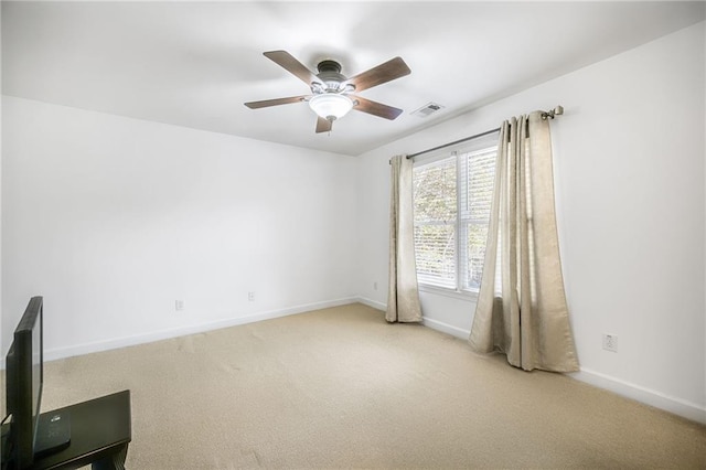 unfurnished room featuring carpet flooring, ceiling fan, visible vents, and baseboards