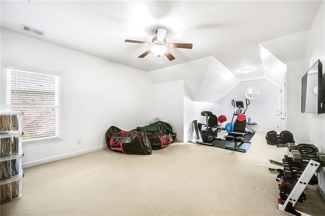 exercise room with carpet, visible vents, vaulted ceiling, and baseboards