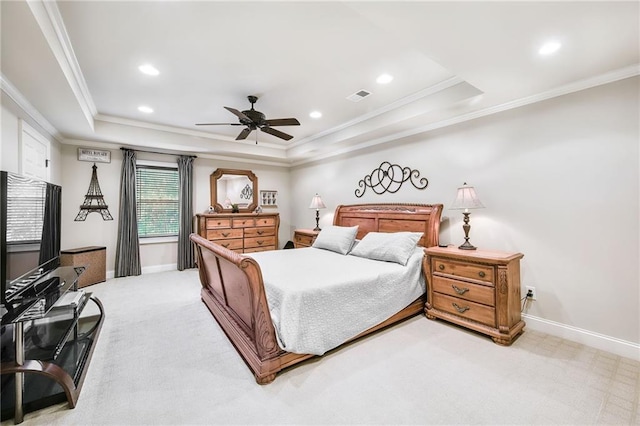 bedroom featuring light carpet, visible vents, a tray ceiling, and baseboards