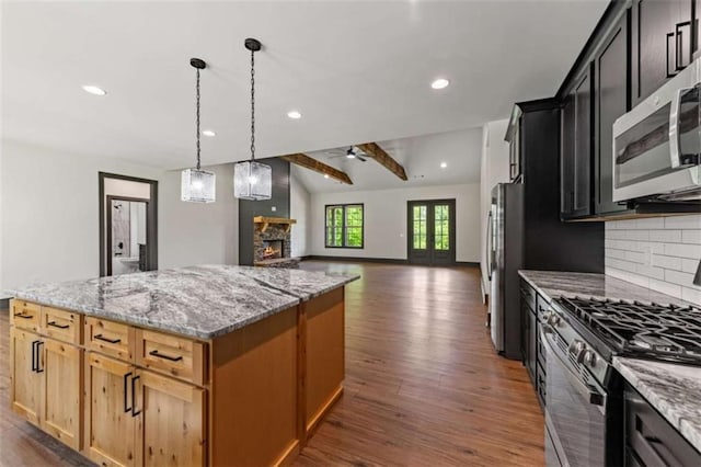2462 New Hope Rd, Morganton, GA 30560 - kitchen with appliances with stainless steel finishes, a fireplace, dark wood finished floors, backsplash, and ceiling fan