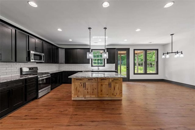 2462 New Hope Rd, Morganton, GA 30560 - kitchen with stainless steel appliances, light stone counters, recessed lighting, tasteful backsplash, and wood finished floors