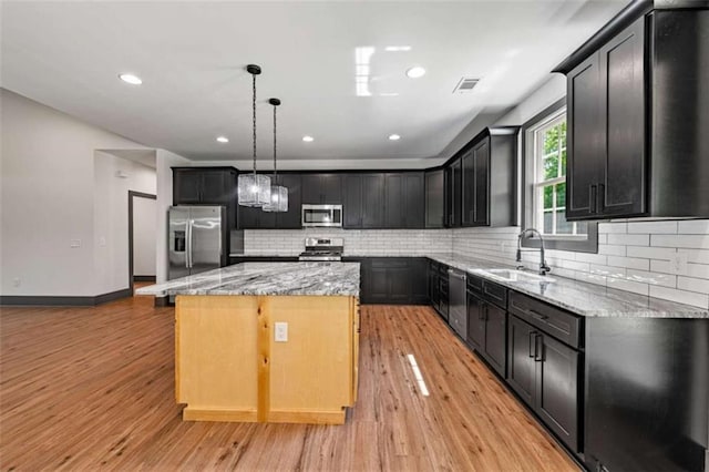 2462 New Hope Rd, Morganton, GA 30560 - kitchen with appliances with stainless steel finishes, a sink, light stone countertops, a center island, and recessed lighting