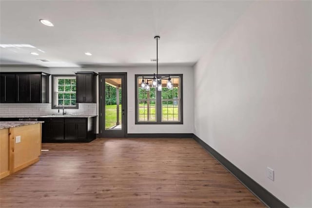 2462 New Hope Rd, Morganton, GA 30560 - kitchen with backsplash, wood finished floors, dark cabinets, baseboards, and recessed lighting
