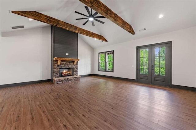 2462 New Hope Rd, Morganton, GA 30560 - unfurnished living room featuring beamed ceiling, wood finished floors, a stone fireplace, a ceiling fan, and baseboards