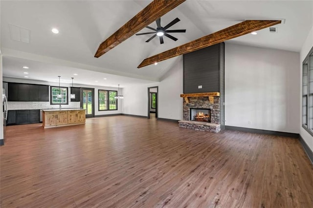 2462 New Hope Rd, Morganton, GA 30560 - unfurnished living room featuring a fireplace, beam ceiling, wood finished floors, a ceiling fan, and baseboards