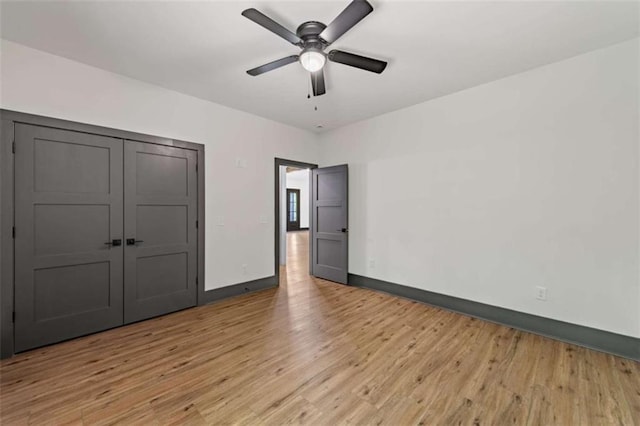 2462 New Hope Rd, Morganton, GA 30560 - unfurnished bedroom featuring baseboards, light wood-style flooring, a ceiling fan, and a closet