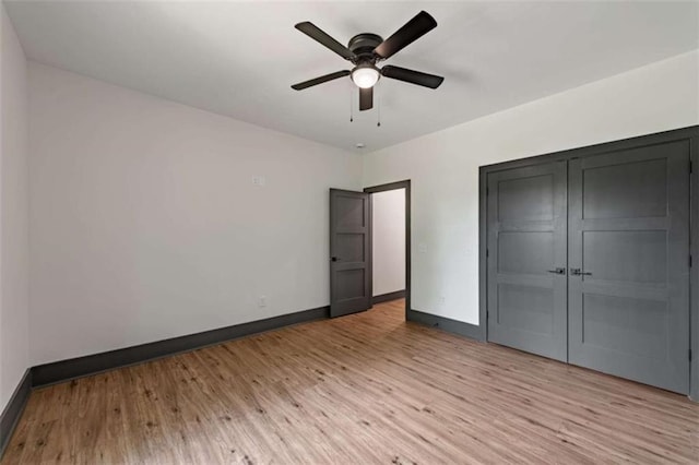2462 New Hope Rd, Morganton, GA 30560 - unfurnished bedroom featuring baseboards, light wood-style floors, a closet, and a ceiling fan