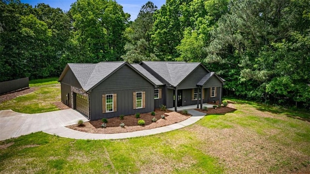 2462 New Hope Rd, Morganton, GA 30560 - ranch-style house with driveway, board and batten siding, a garage, a front yard, and covered porch
