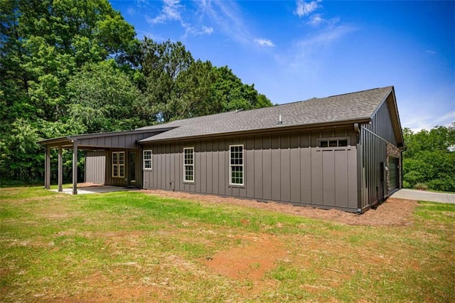 2462 New Hope Rd, Morganton, GA 30560 - back of house featuring board and batten siding, a yard, a garage, and a shingled roof