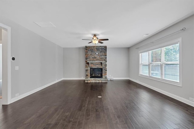 unfurnished living room featuring a fireplace, dark hardwood / wood-style floors, and ceiling fan