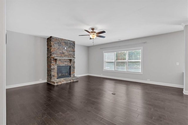 unfurnished living room with dark hardwood / wood-style floors, ceiling fan, and a fireplace