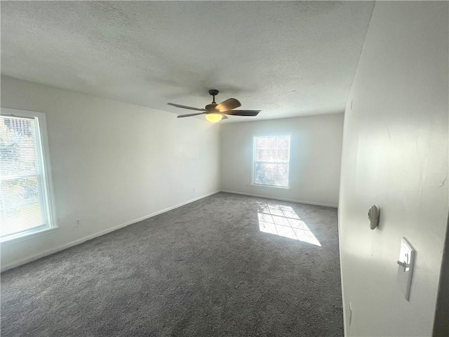 unfurnished room with baseboards, carpet, a ceiling fan, and a textured ceiling