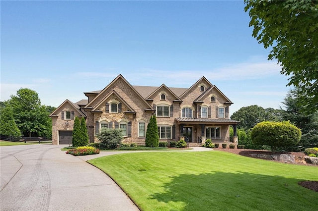 view of front of home featuring a garage and a front lawn