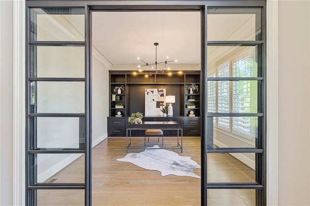 bar featuring hardwood / wood-style floors, built in features, a chandelier, ornamental molding, and french doors