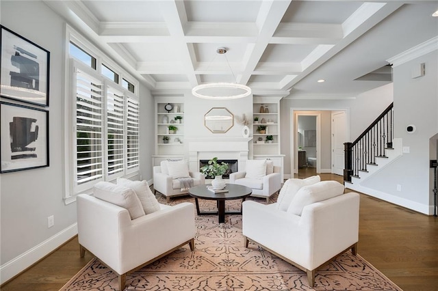 living room featuring coffered ceiling, hardwood / wood-style floors, beam ceiling, and built in features