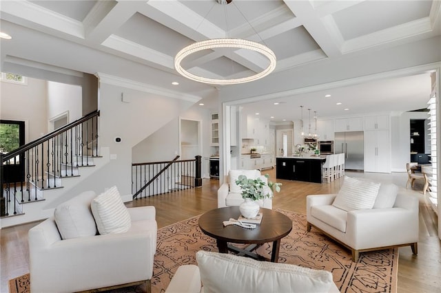 living room featuring beamed ceiling, coffered ceiling, and light hardwood / wood-style floors