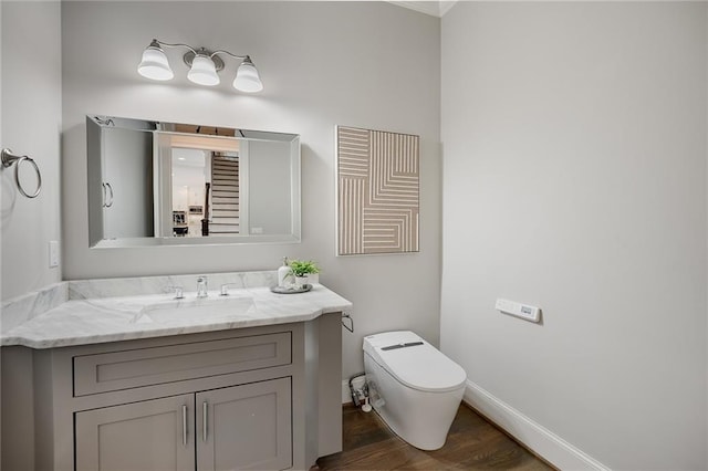 bathroom featuring vanity, toilet, and wood-type flooring