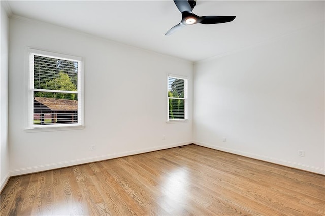 spare room featuring ceiling fan, ornamental molding, and light wood-type flooring