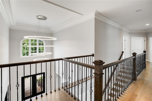 hallway featuring hardwood / wood-style floors and crown molding