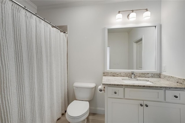 bathroom featuring vanity, crown molding, and toilet