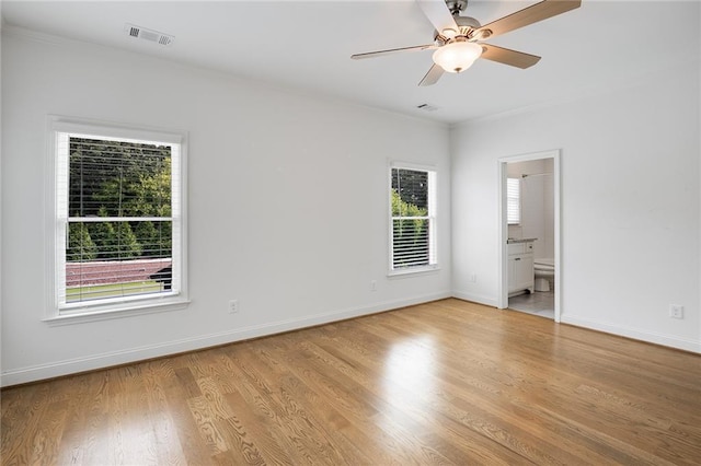 spare room featuring ceiling fan and light hardwood / wood-style flooring