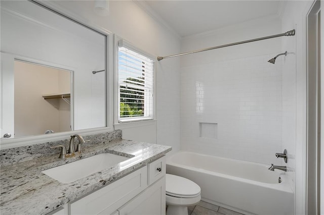 full bathroom featuring tiled shower / bath combo, ornamental molding, vanity, toilet, and tile patterned floors