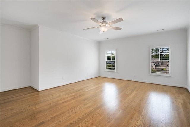 unfurnished room with ceiling fan, ornamental molding, and light wood-type flooring