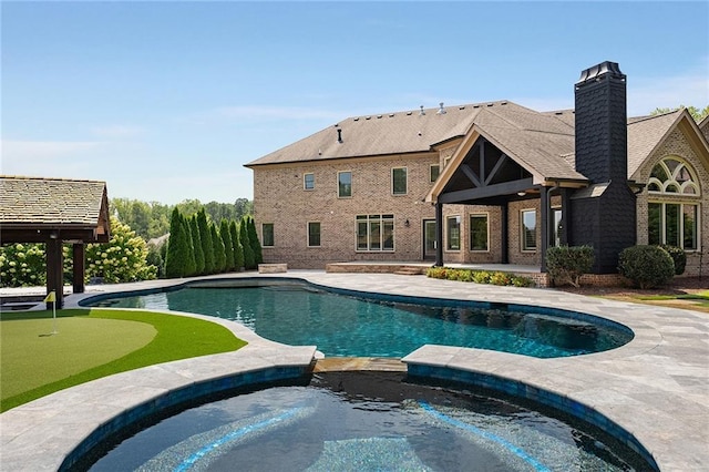 view of swimming pool featuring an in ground hot tub and a patio