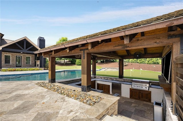 view of patio with area for grilling and exterior kitchen