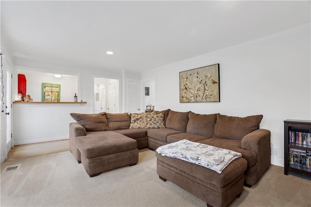 living room featuring crown molding and light carpet