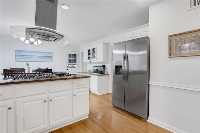 kitchen with white cabinetry, light wood-type flooring, island exhaust hood, and appliances with stainless steel finishes